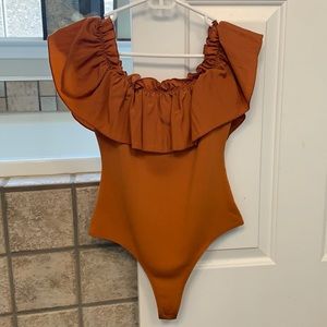 Tcec burnt orange body suit, size small. Can be worn on the shoulder or off